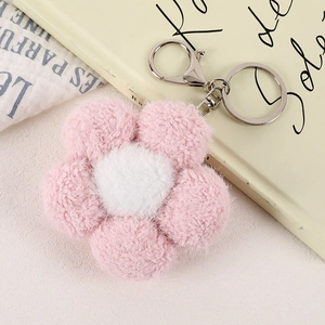 Detailed view of a soft plush pink flower keychain with shiny silver metal lobster clasp