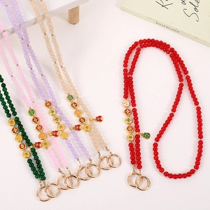 Close-up of colorful beaded phone straps with golden fortune bag and ruyi charms