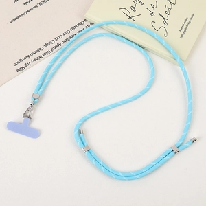 Detail of blue braided crossbody phone lanyard with purple patch and silver hardware