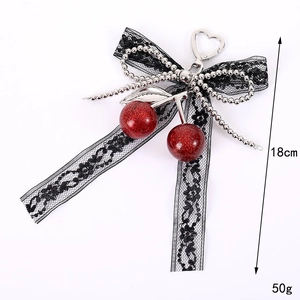 Cute cherry bag charm with lace bow and silver chain details, 18cm height and 50g weight