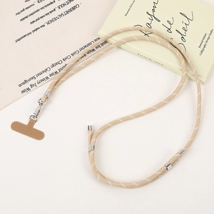 Detail of hand-woven beige crossbody phone lanyard with silver metal adjustment buckle