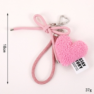 Pink plush heart charm with leather bow decoration and braided strap 18cm long
