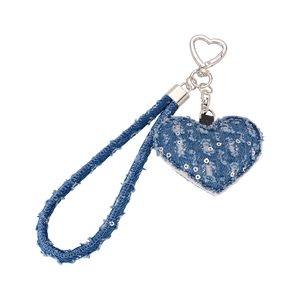 Detail of blue denim heart charm with silver sequins and metallic heart carabiner