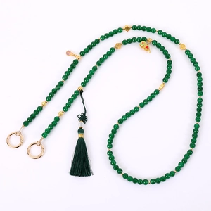 Green beaded crossbody bag chain with vintage gourd pendant and silk tassel detail
