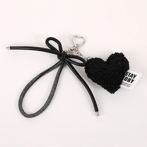 Minimalist black plush heart bag charm with a stylish bow and silver metal chain