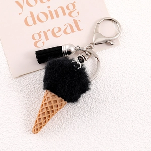 Detailed close-up of ice cream charm with black faux fur ball and leather tassel