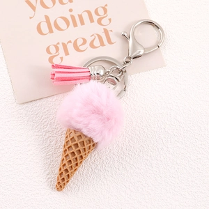 Detail of pink faux fur ice cream keychain with brown cone and leather tassel