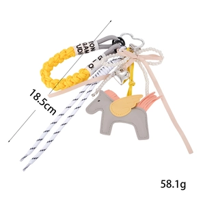 Cute gray leather pegasus bag charm with yellow wings and braided rope strap accessory