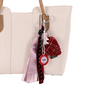 Houndstooth woven rope bag charm with red heart pendant and poker chip accessory