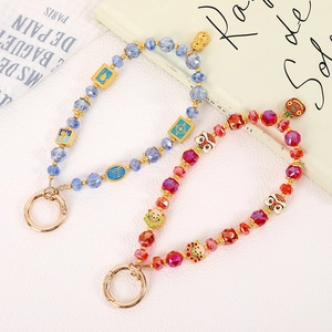Chinese style beaded phone charms with lion dance and tiger enamel pendants in red and blue