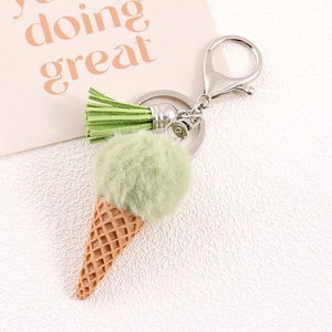 Detail of light green faux rabbit fur ice cream keychain with tassel and silver clasp