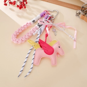 Detailed view of pink leather Pegasus charm with red wings and heart-shaped metal clip