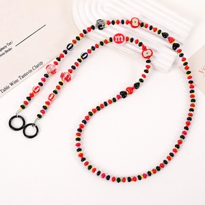 Detailed macro shot of handmade colorful m&m style beaded chain with secure black rings