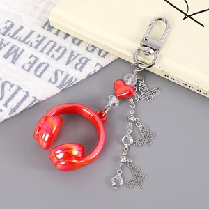 Detail of red music headphone keychain with silver butterflies and beaded heart accents