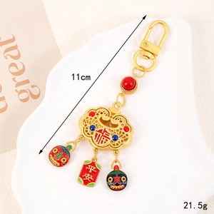 Macro detail of alloy gold lock keychain with red enamel and Chinese Fu characters