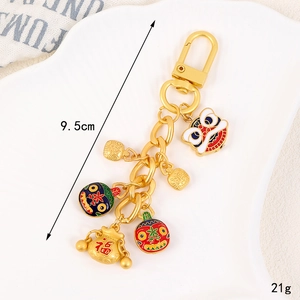 Porte-clés lion chinois doré avec pendentifs pièces de monnaie sur plateau céramique