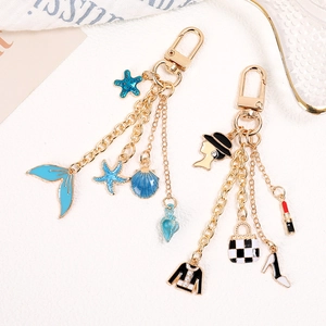 Chic gold lobster clasp keychain featuring stylish enamel sea life and fashion charm pendants