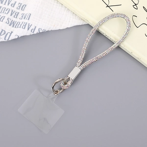Macro shot of colorful rhinestone phone wrist strap with silver metal ring and clear patch