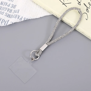 Detail view of luxury sparkling rhinestone phone wrist strap with silver metal ring