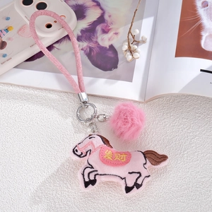 Pink plush horse keychain with fluffy fur ball and woven strap for bags and phones