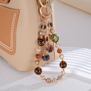 Leopard print bead and faux fur pompom phone wrist strap with gold metal clasp