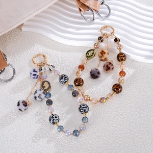 Leopard print beaded phone strap with plush balls and gold spring buckle for women