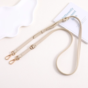Adjustable cream lychee leather bag strap with golden hardware and lobster clasps