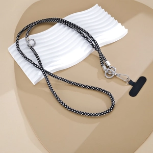 Detail of shimmering black rhinestone phone lanyard with silver metal ring and T-connector