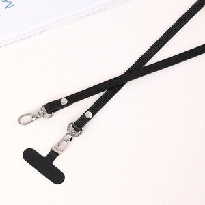 Macro detail of PU leather crossbody phone strap with Greca pattern and silver buckle