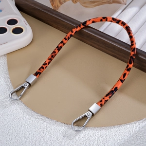 Detailed view of leopard print PU leather wrist strap with silver metal spring buckles