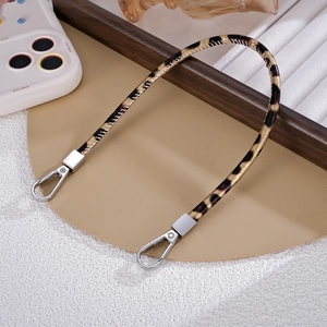 Close-up of leopard print PU leather handbag strap with silver metal spring clasps