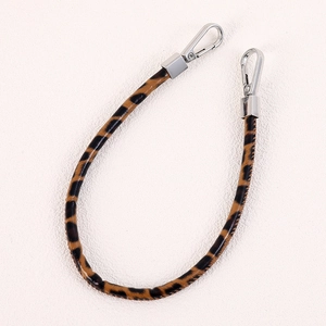 Leopard print PU leather bag strap with silver metal lobster clasps on white background