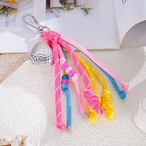 Detailed close-up of macaron-colored braided cord charms with silver heart-shaped pendants