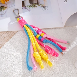 Detailed close-up of colorful braided rope keychain with vibrant beads and metal clip
