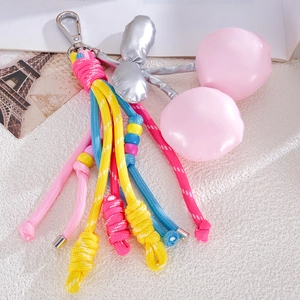 Detail view of handmade braided nylon rope with pink PU leather cherries and silver leaves