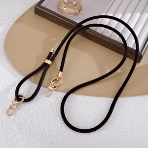 Detail of dark brown braided PU leather strap with golden lobster clasps and slider