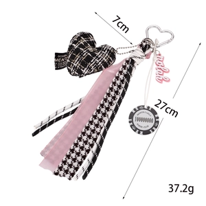 Pink heart keychain with plaid fabric charm and poker chip decorative strap