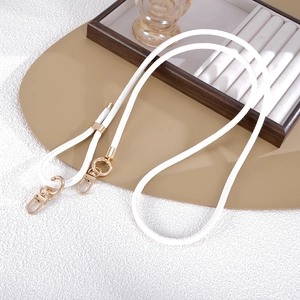 Close-up of white PU leather lanyard with polished gold lobster clasps and rings
