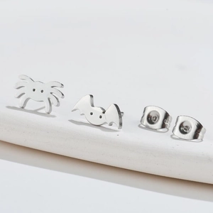 Detailed macro view of Gothic punk bat and spider stainless steel stud earring set