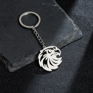 Polished stainless steel keychain featuring a hollow eagle head charm on slate stone
