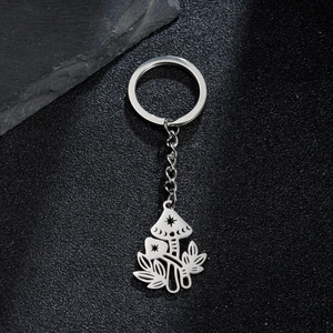 Stainless steel mushroom keychain with moon and star cutout charms on a textured background