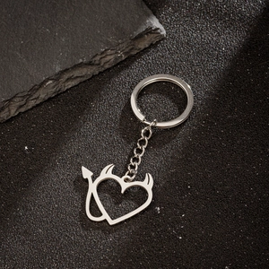 Polished silver heart devil metal keychain with horn and tail details on black background