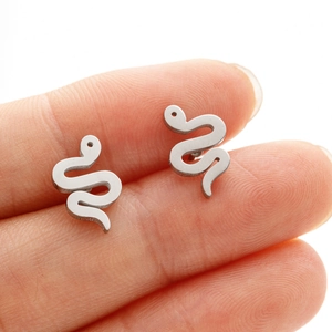 Detailed close-up of S-shaped snake stud earrings in polished silver stainless steel