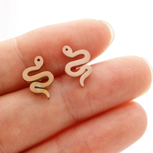 Detailed close-up of rose gold snake earrings featuring polished stainless steel finish
