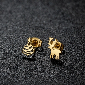 Close-up of golden asymmetric Christmas tree and elk studs on black textured background