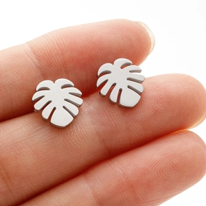 Macro view of palm leaf earrings in silver with a delicate brushed matte finish