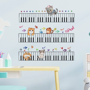 Detail view of cute cartoon cats playing piano keyboard wall decals in kids room decor