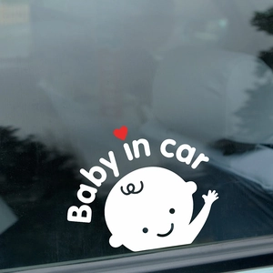 Baby in car car sticker with cute cartoon baby and red heart on rear car window glass