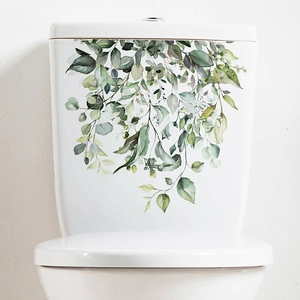 Detail of watercolor green eucalyptus leaf wall decal on a white ceramic toilet tank