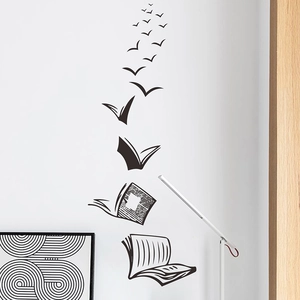 Modern black wall decal featuring books transforming into flying birds for home decor